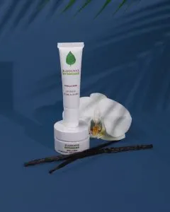 Arbonne botaniques vanilla bean lip salve and lip smoother with vanilla beans on blue background