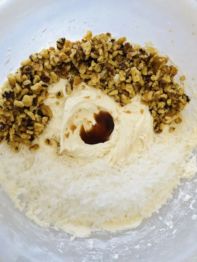 mixing walnuts into coconut mixture