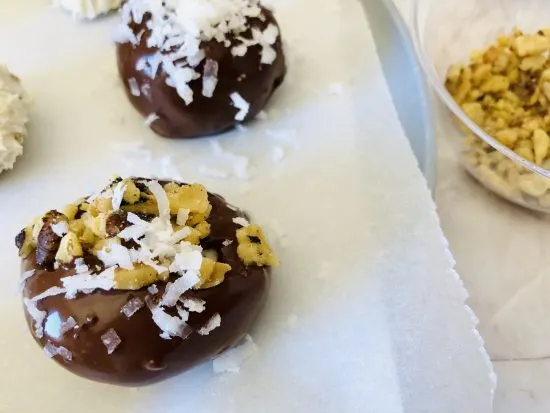 completed truffles coated with shredded coconut and chopped walnuts