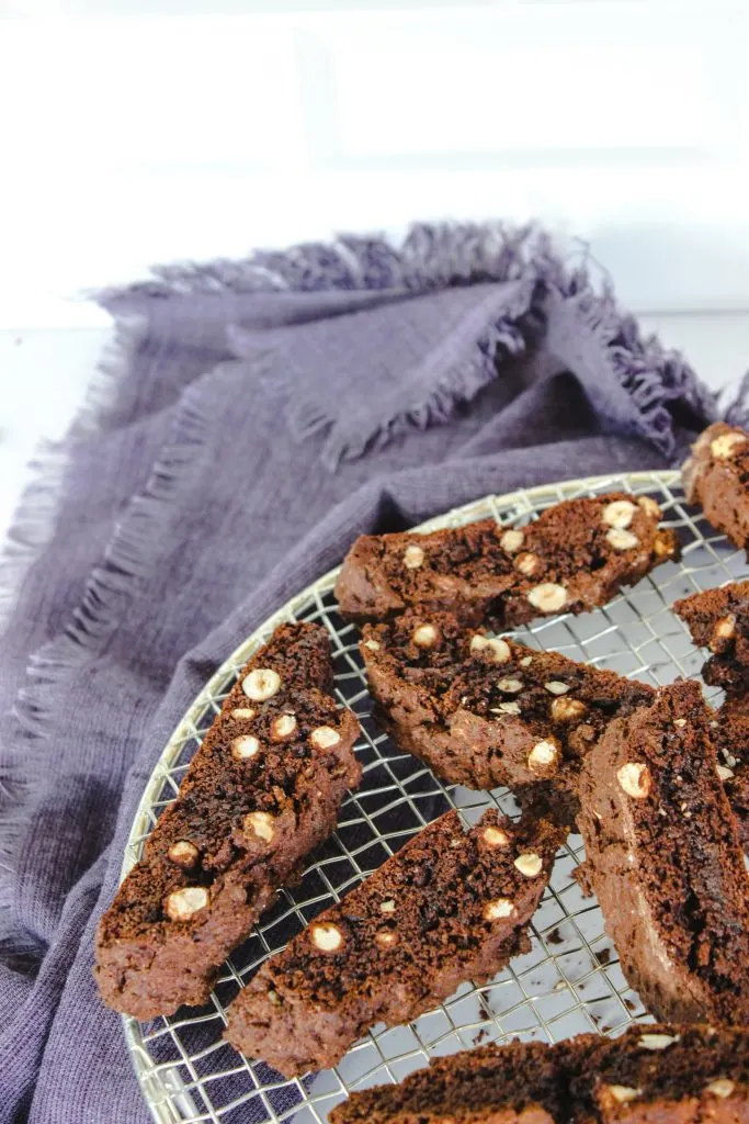 chocolate hazelnut biscotti cooling on rack with blue towel