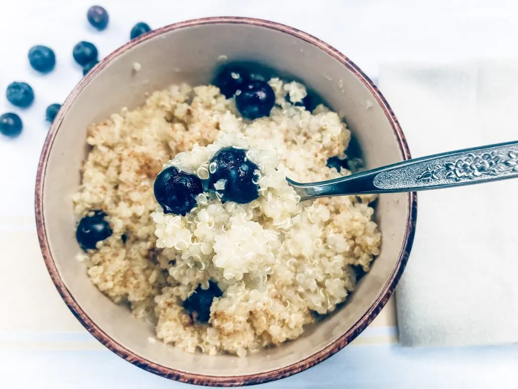Microwave Breakfast Quinoa finished picture topped with cinnamon and blueberries
