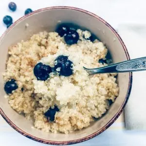 breakfast quinoa with spoon and blueberries