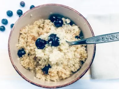 breakfast quinoa with spoon and blueberries