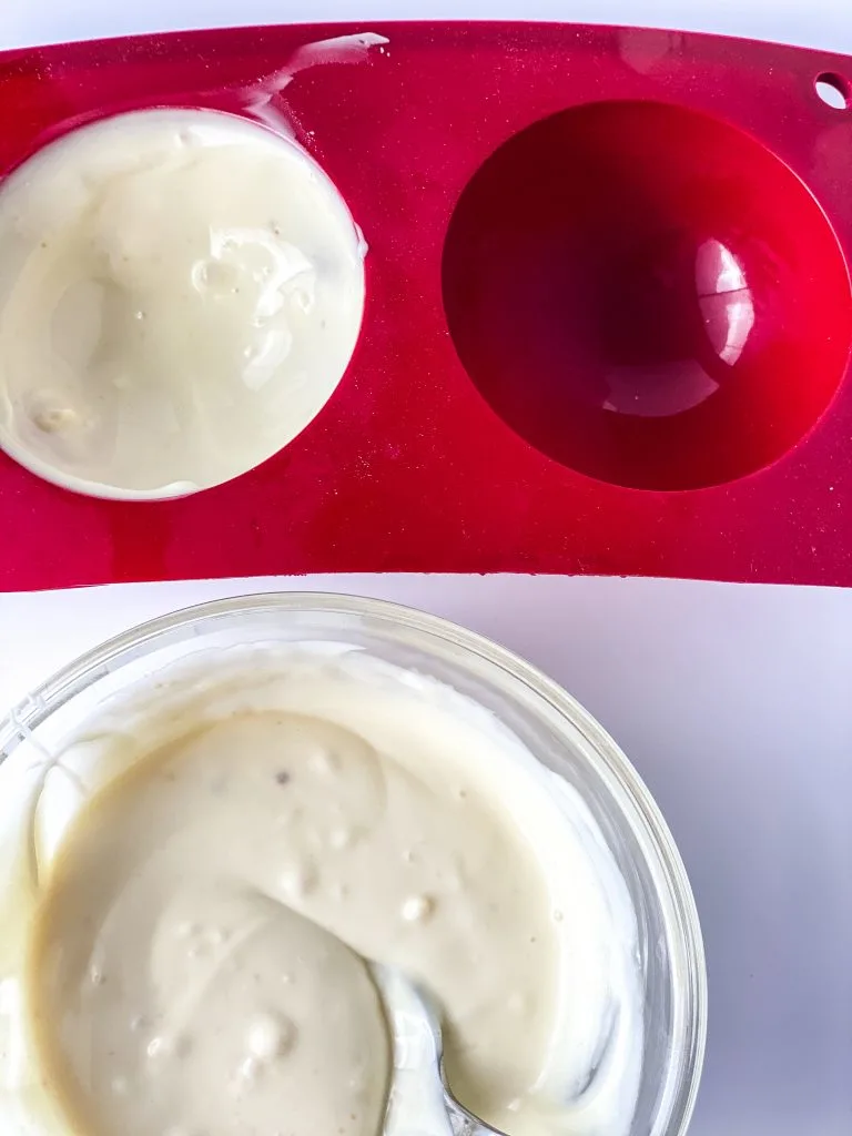 coating the molds with melted white chocolate