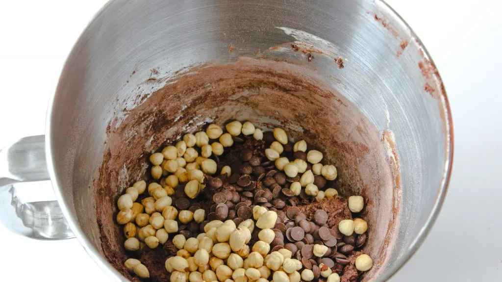 stirring in chocolate chips and hazelnuts into biscotti mixture