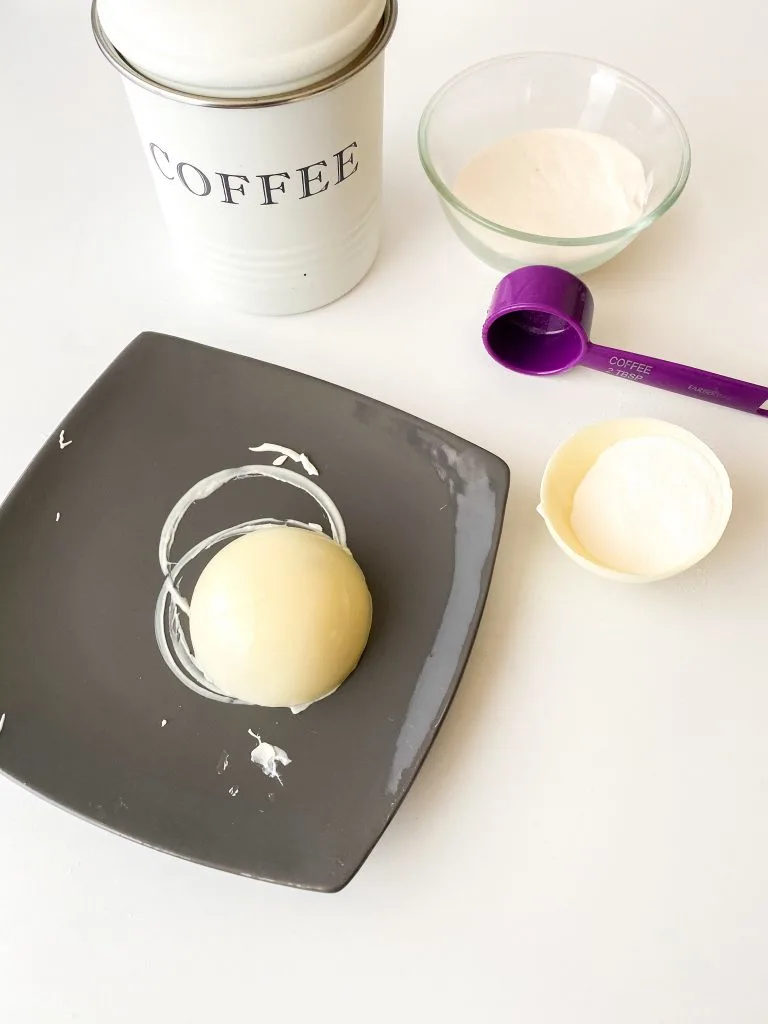 hot plate method melting edge of coffee bomb with white chocolate coffee bomb half and tablespoon scooper
