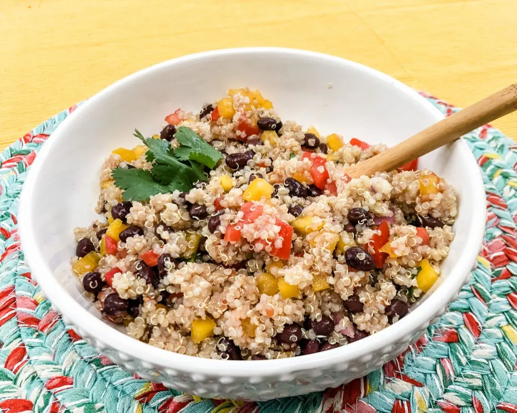 side view of quinoa salad with spoon on mat