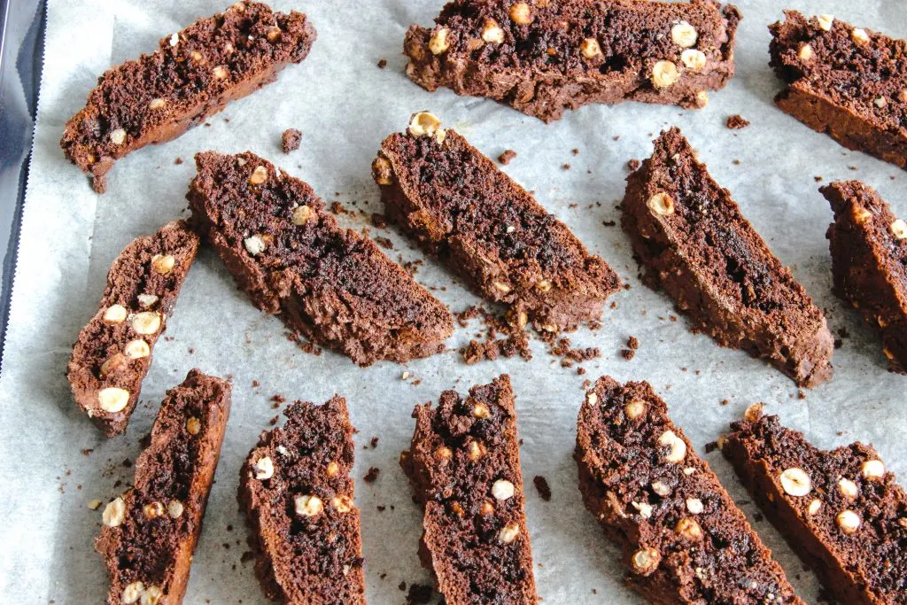 sliced biscotti on baking sheet and parchment ready for second baking