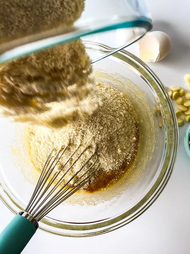 adding dry ingredients to bowl