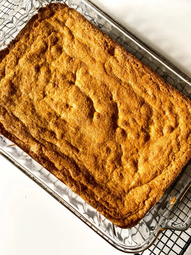 baked gluten free blondies in pan, cooling