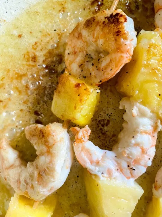 shrimp and pineapple cooking in pan