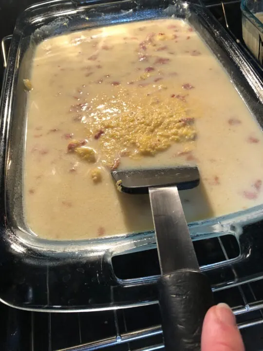 polenta being stirred in the oven