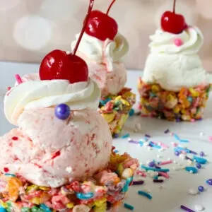 Close Up Fruity Pebble Ice Cream Cups with sprinkles and pink background