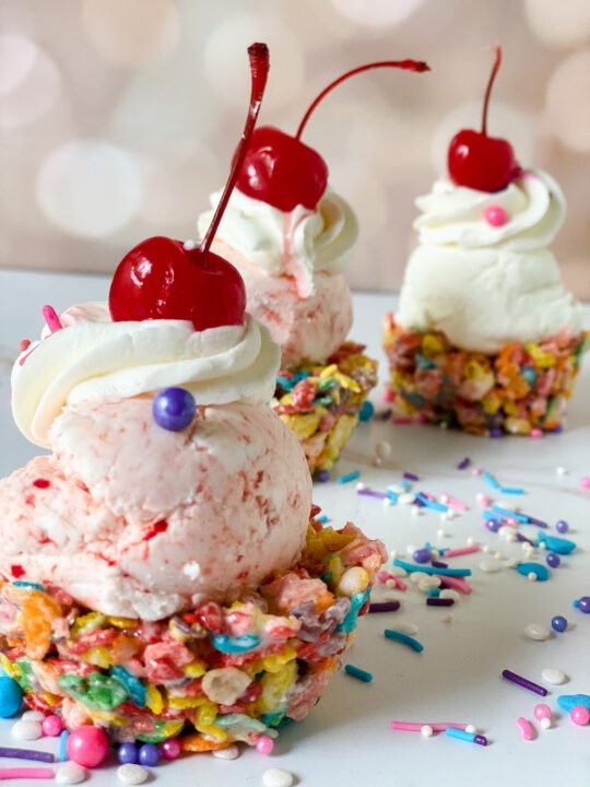 Close Up Fruity Pebble Ice Cream Cups with sprinkles and pink background