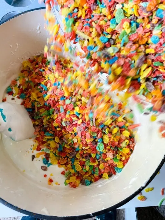 Stirring Fruity Pebbles into Marshmallows in Dutch Oven