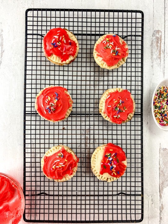 Gluten free Pop Tarts on cooling rack Topped with Icing and sprinkles