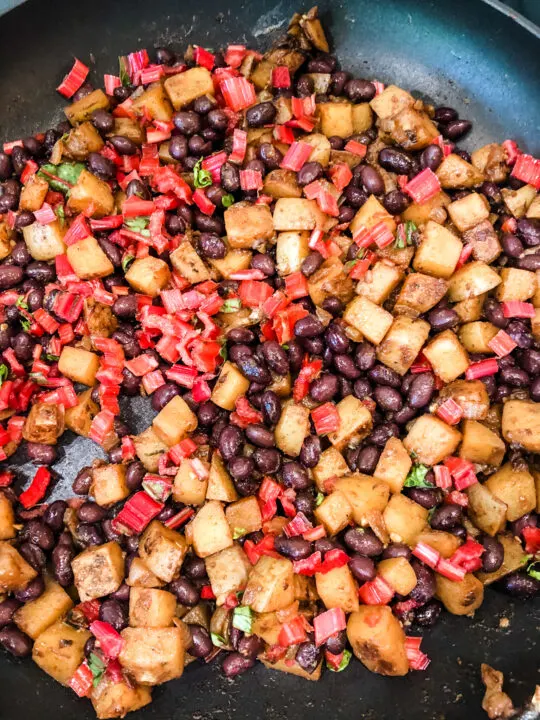 black beans potato and swiss chard stems in skillet