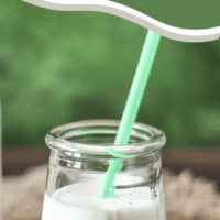gluten-free almond milk in glass with straw