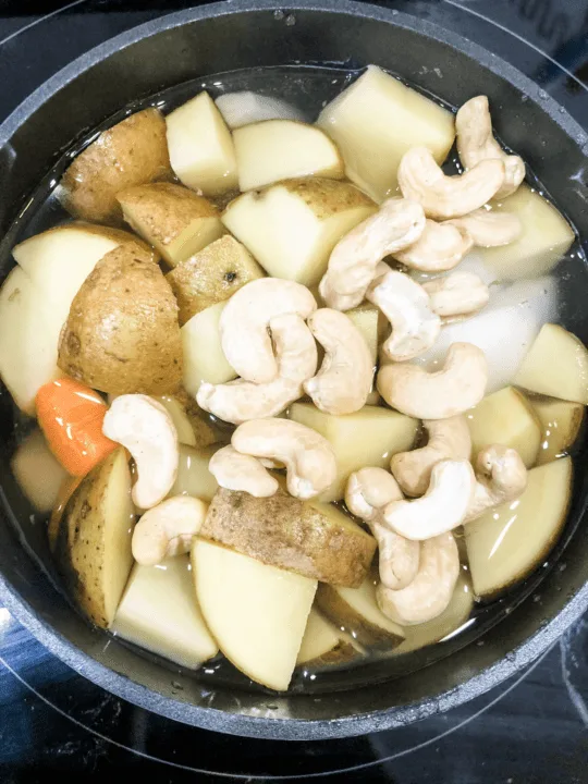 vegetables and cashews in saucepan ready to boil