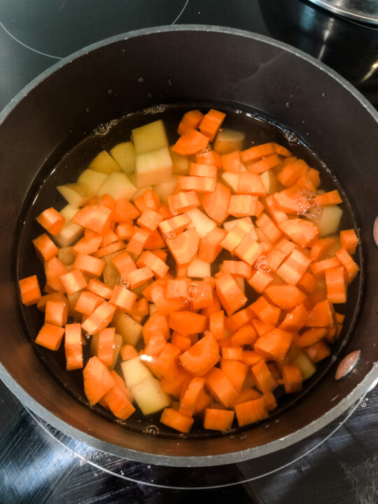 carrots and potatoes for tomato soup boiling
