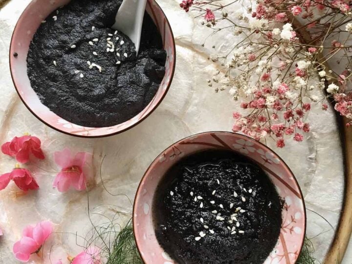black sesame tong sui in pink bowls on platter with flowers