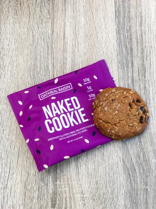 oatmeal raisin naked cookie sitting on wrapper on wooden table