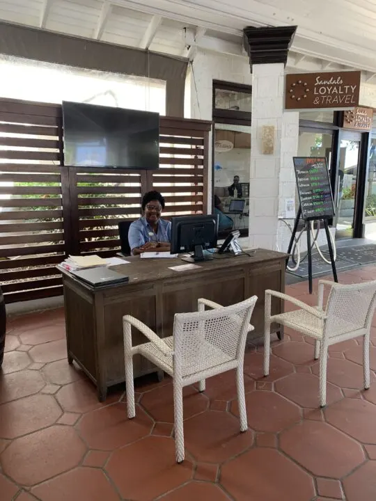 Culinary Concierge sitting at desk at Sandals Negril Resort