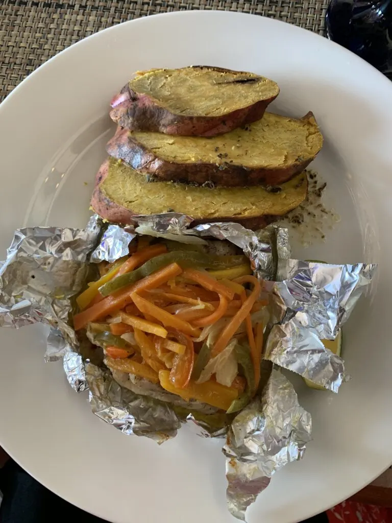 gluten free meal of fish and veggies in foil with roasted potato at Sandals Resort