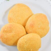 gluten free pumpkin rolls on ceramic plate with thyme and rosemary