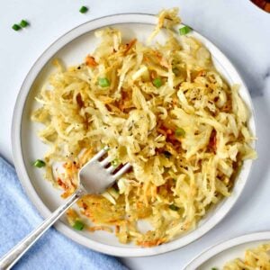 air fryer hash browns on plate with fork