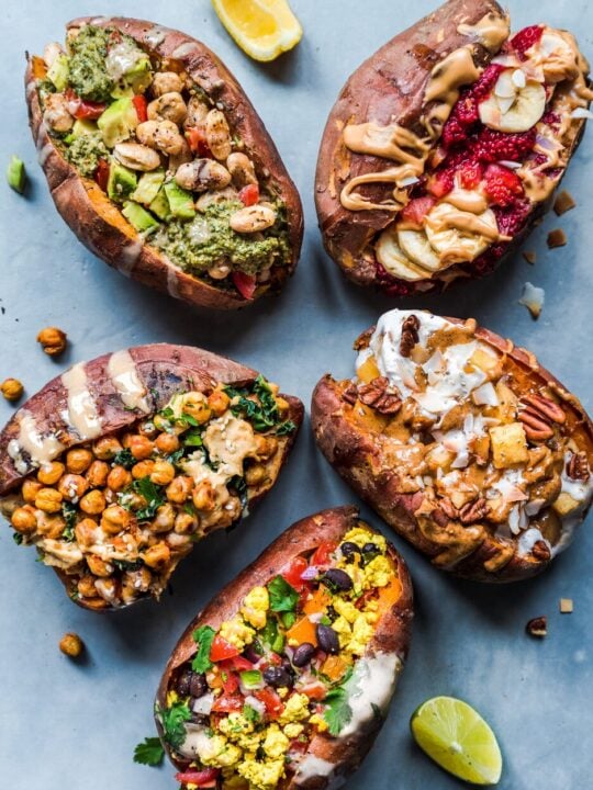 baked sweet potatoes with five different toppings, lemon wedge, and lime wedge