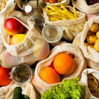 variety of low fodmap fruits and vegetables in mesh sacks