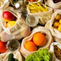 variety of low fodmap fruits and vegetables in mesh sacks