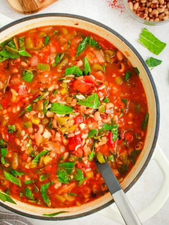 gluten free vegan smoky black eyed pea and tomato soup in dutch oven with spoon