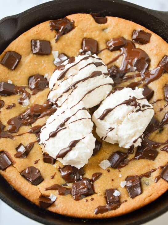 melty gluten free vegan chocolate chip cookie skillet topped with dairy free ice cream