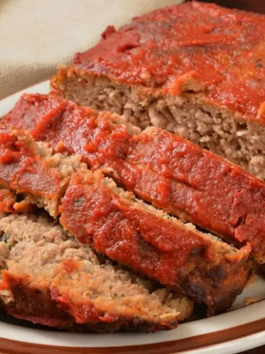gluten free Italian meatloaf topped with ketchup and sliced on plate