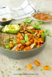 Copycat True Foods Kitchen Ancient Grains Bowl topped with homemade dressing and avocado