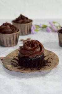 gluten free chocolate cupcakes with chocolate butter cream on paper wrapper