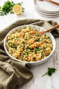 sweet potato quinoa salad in bowl with wooden spoon