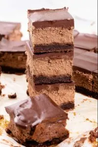 low carb triple chocolate cheesecake bars stacked