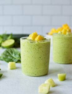 spinach cucumber smoothie topped with mango