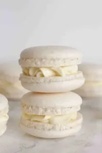 stack of 2 vegan vanilla macarons on white marble