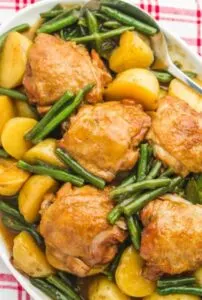 gf instant pot honey chicken thighs with potatoes and green beans in bowl with spoon
