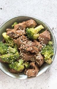 gluten free instant pot beef and broccoli in bowl topped with sesame seeds