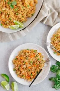instant pot mexican rice on plates with lime wedges
