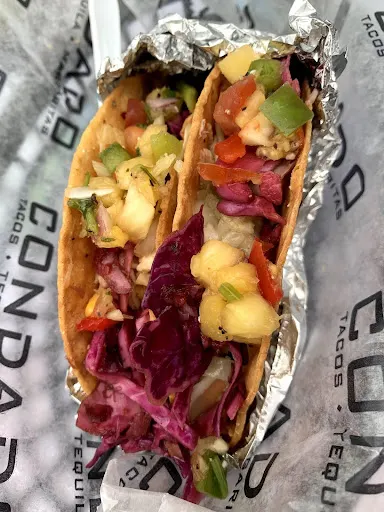 Gf tacos topped with pineapple salsa from Condado’s Indiana