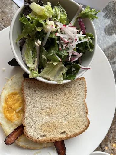 gluten free bacon and egg with toast and salad on a plate from Rize in Indiana