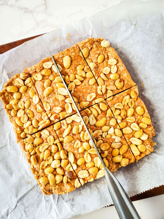 peanut protein bars on parchment paper sliced into 8 pieces