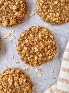 gluten free vegan oatmeal protein cookies on countertop with tea towel