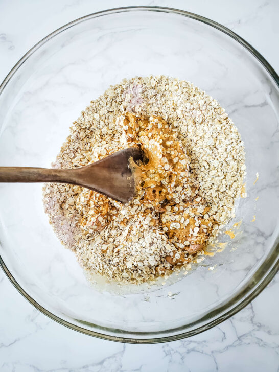 ingredients for peanut protein bars mixing in glass bowl